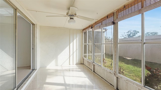 unfurnished sunroom with ceiling fan