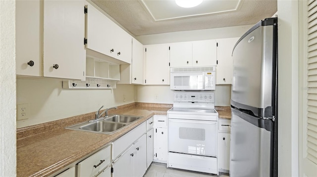 kitchen with sink, white appliances, and white cabinets