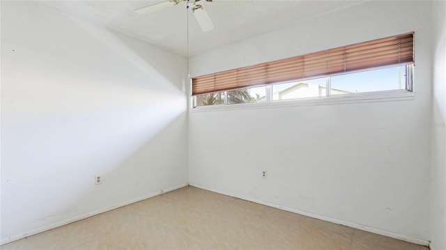 unfurnished room with ceiling fan and a healthy amount of sunlight