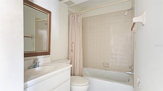 full bathroom with shower / tub combo with curtain, vanity, and toilet