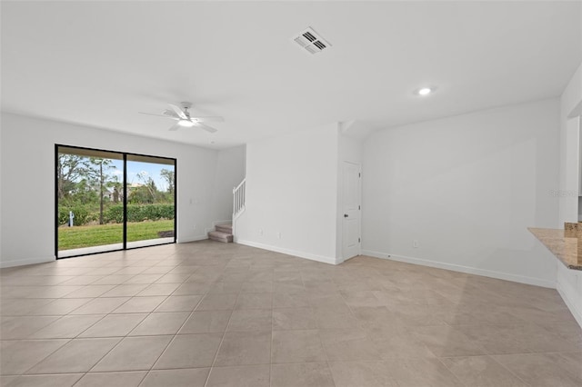 unfurnished living room with light tile patterned floors and ceiling fan