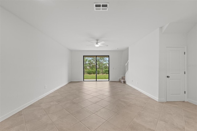 tiled empty room with ceiling fan