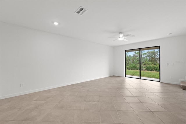 empty room featuring light tile patterned floors and ceiling fan