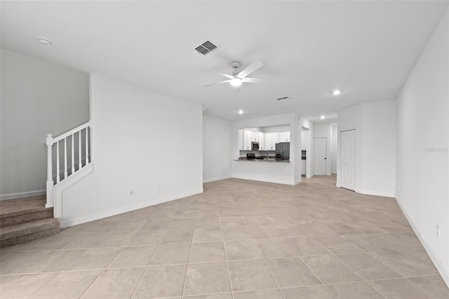 unfurnished living room with light tile patterned floors and ceiling fan