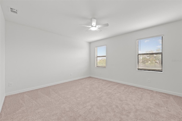 empty room featuring light carpet and ceiling fan