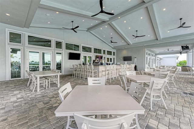 dining room featuring beam ceiling, high vaulted ceiling, ceiling fan, and french doors