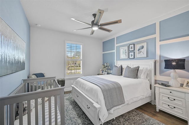 bedroom featuring dark hardwood / wood-style floors and ceiling fan