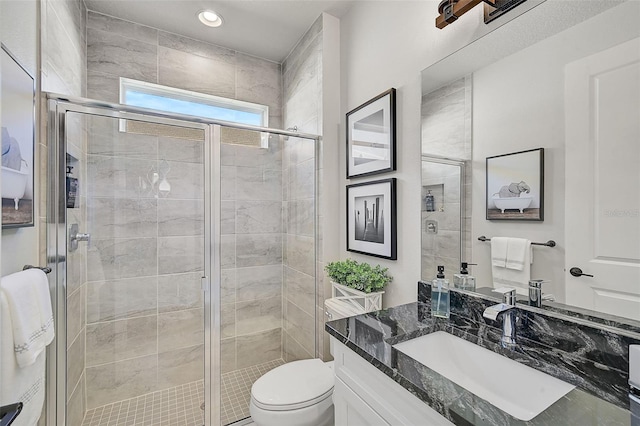 bathroom featuring walk in shower, vanity, and toilet