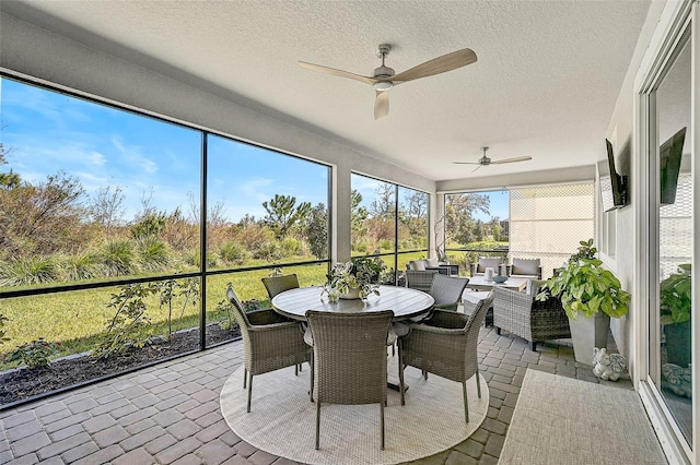 sunroom featuring ceiling fan