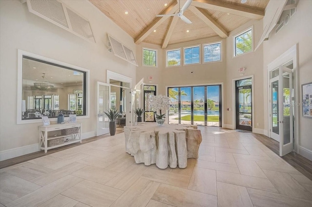 interior space featuring a high ceiling, ceiling fan, wooden ceiling, beam ceiling, and french doors