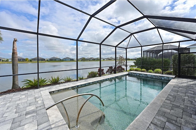 view of swimming pool featuring a water view, glass enclosure, and a patio area