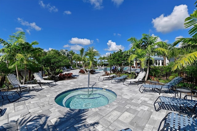 view of pool featuring a community hot tub and a patio area