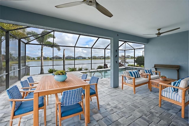 sunroom with a water view and ceiling fan