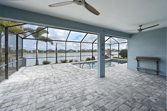 view of swimming pool with a water view, a lanai, and a patio area