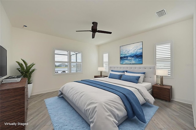 bedroom featuring light hardwood / wood-style floors and ceiling fan