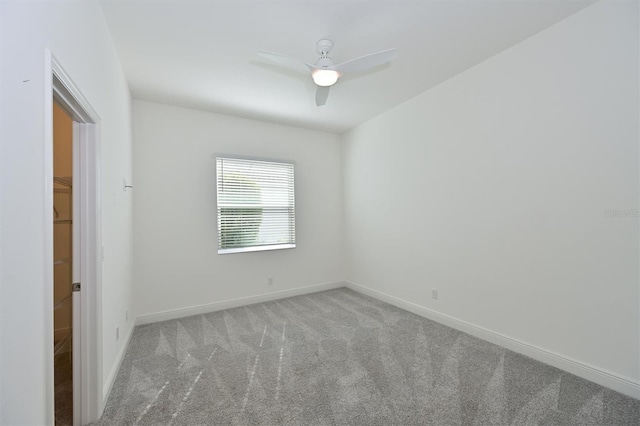 empty room with light colored carpet and ceiling fan