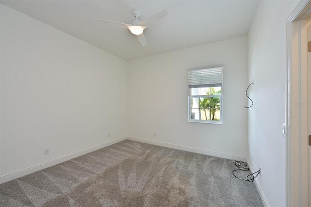 empty room featuring carpet floors and ceiling fan