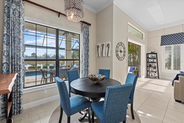 dining area featuring crown molding and light tile patterned floors