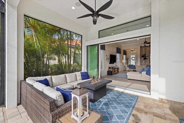 sunroom / solarium featuring a wealth of natural light and ceiling fan