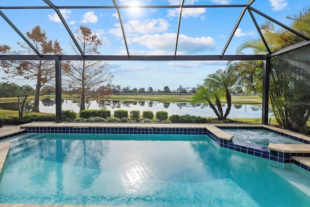 view of pool featuring glass enclosure, a water view, and a pool with connected hot tub