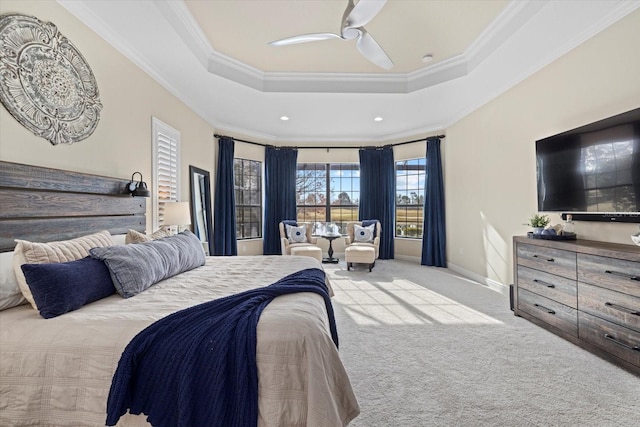 bedroom featuring baseboards, a tray ceiling, carpet flooring, and ornamental molding