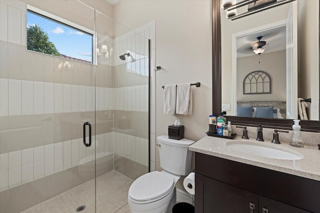 full bathroom featuring toilet, a shower stall, and vanity