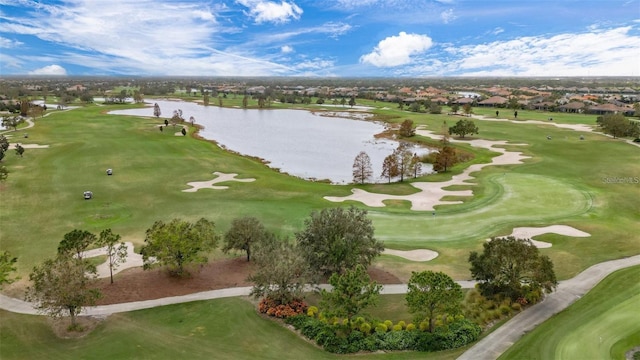 birds eye view of property featuring golf course view and a water view