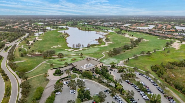 birds eye view of property featuring golf course view and a water view