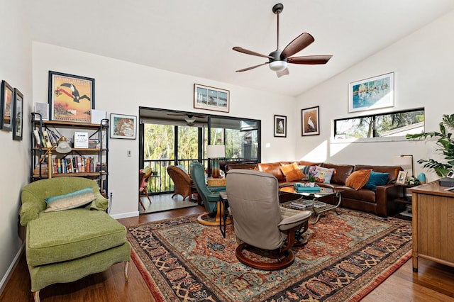 living room featuring vaulted ceiling, wood-type flooring, and ceiling fan