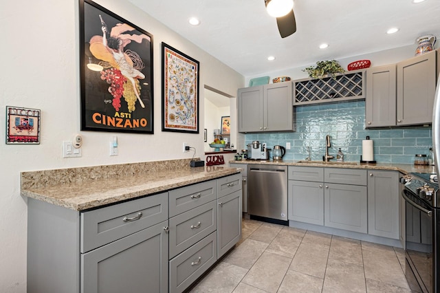 kitchen featuring gray cabinets, dishwasher, sink, decorative backsplash, and electric range