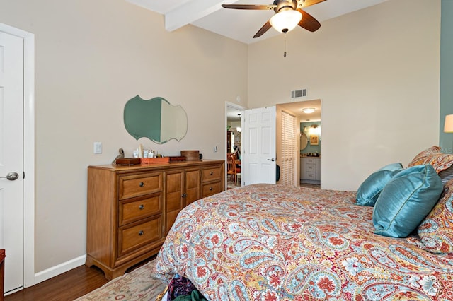 bedroom with dark wood-type flooring, connected bathroom, high vaulted ceiling, beamed ceiling, and ceiling fan