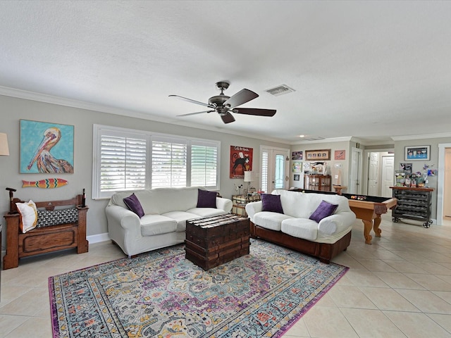 living room featuring light tile patterned flooring, french doors, a textured ceiling, ornamental molding, and ceiling fan