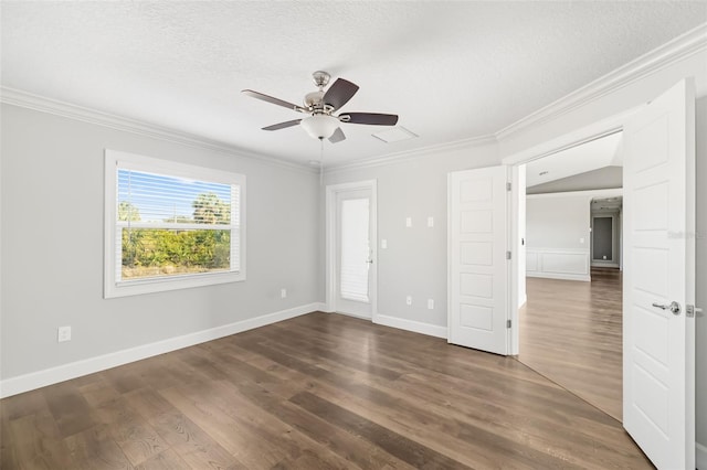 spare room featuring ceiling fan, crown molding, dark wood-type flooring, and a textured ceiling