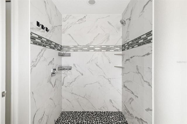 bathroom with a tile shower