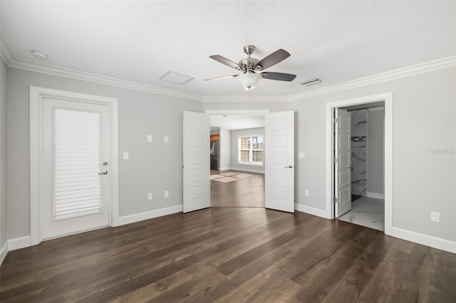 unfurnished bedroom featuring dark hardwood / wood-style flooring, crown molding, ensuite bath, and ceiling fan