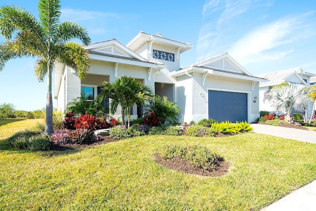 view of front of property featuring a garage and a front yard