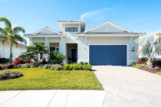 view of front of property with a garage and a front yard