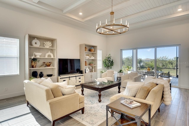 living room with beamed ceiling and an inviting chandelier