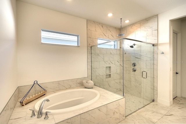 bathroom featuring separate shower and tub