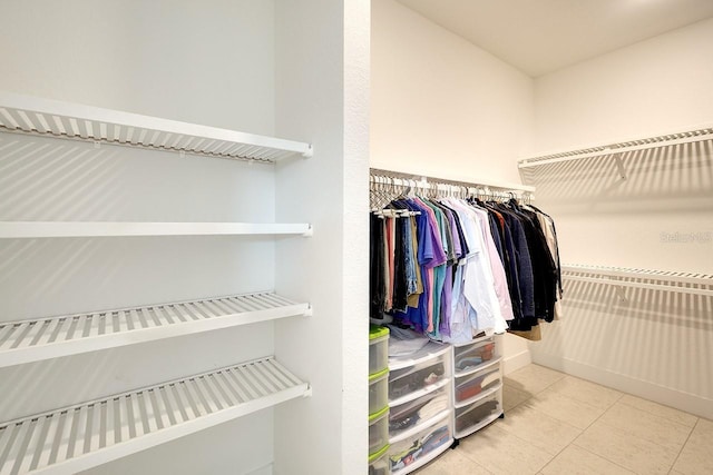 walk in closet featuring light tile patterned flooring