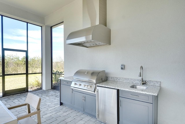 view of patio featuring sink, grilling area, and exterior kitchen