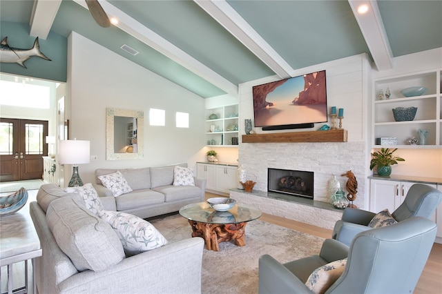 living room with french doors, light hardwood / wood-style floors, built in features, and vaulted ceiling with beams