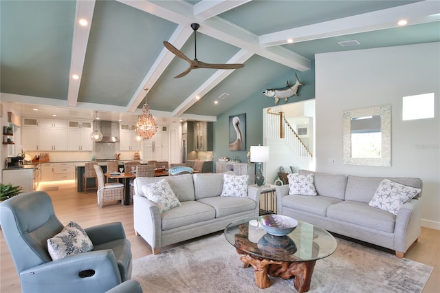 living room with ceiling fan, high vaulted ceiling, beam ceiling, and light hardwood / wood-style flooring