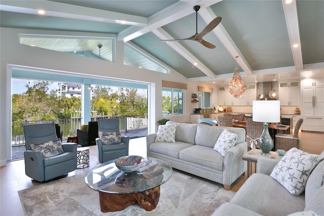 living room with vaulted ceiling with beams and ceiling fan with notable chandelier