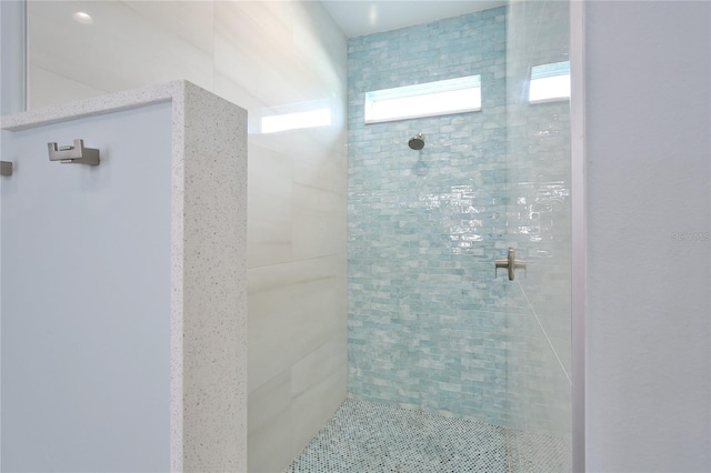 bathroom with a tile shower