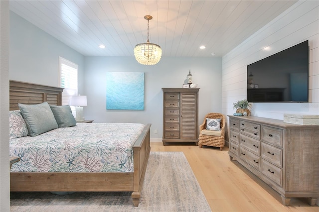 bedroom featuring a notable chandelier, wooden ceiling, and light wood-type flooring