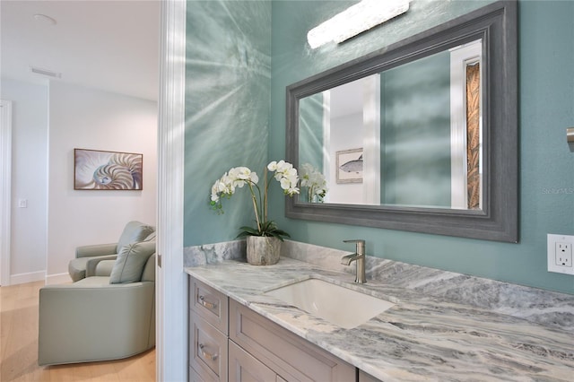 bathroom featuring vanity and hardwood / wood-style floors