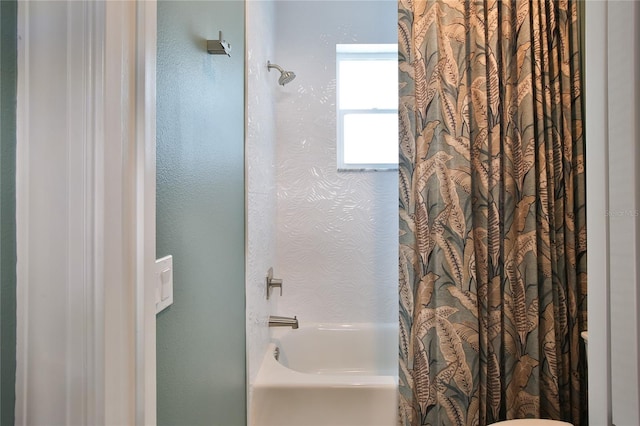 bathroom with shower / bath combo with shower curtain