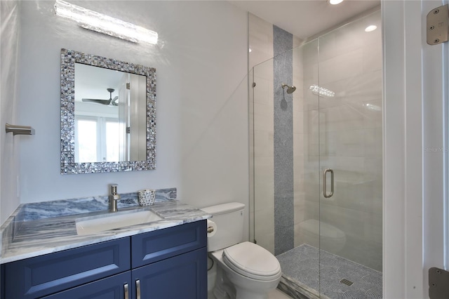 bathroom featuring toilet, vanity, and walk in shower