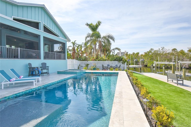 view of pool featuring a water view and a lawn